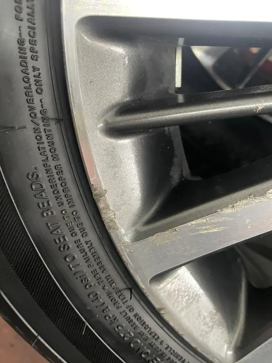 Before repair rim damage across wheel edge and spoke face